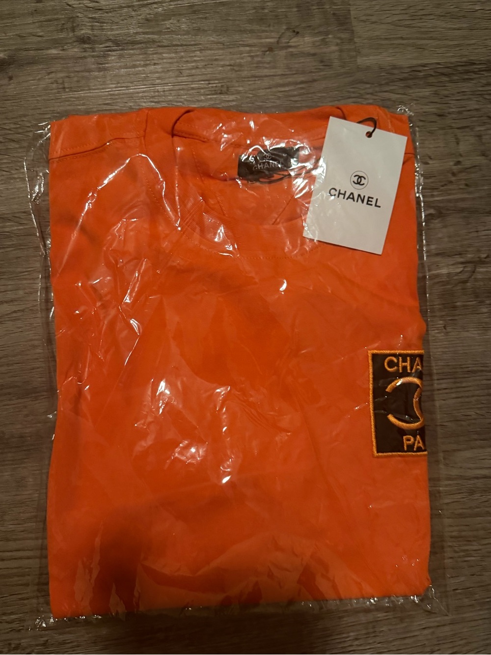 CHANEL Men’s Bright Orange Logo Patch Short Sleeve Tee